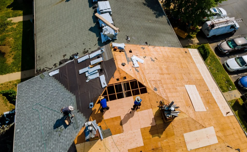 Top View of Contractors Working on Roof Shingles in Texas - TSG Roofing