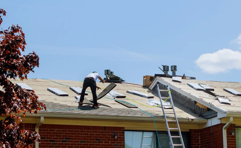 Contractor Working on Roof Shingles in Texas - TSG Roofing
