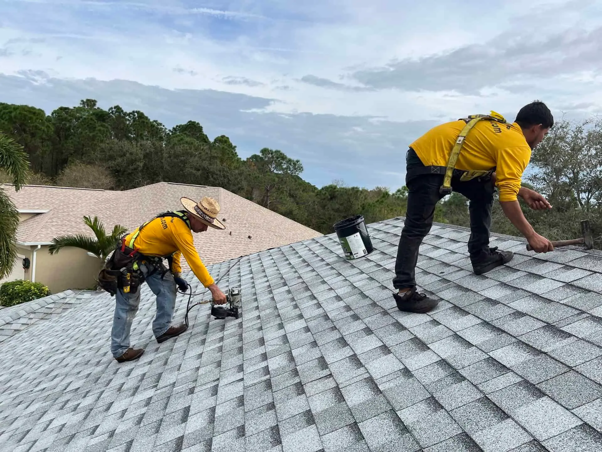 Two Guys in Yellow Shirt Fixing the Roof in Texas - TSG Roofing